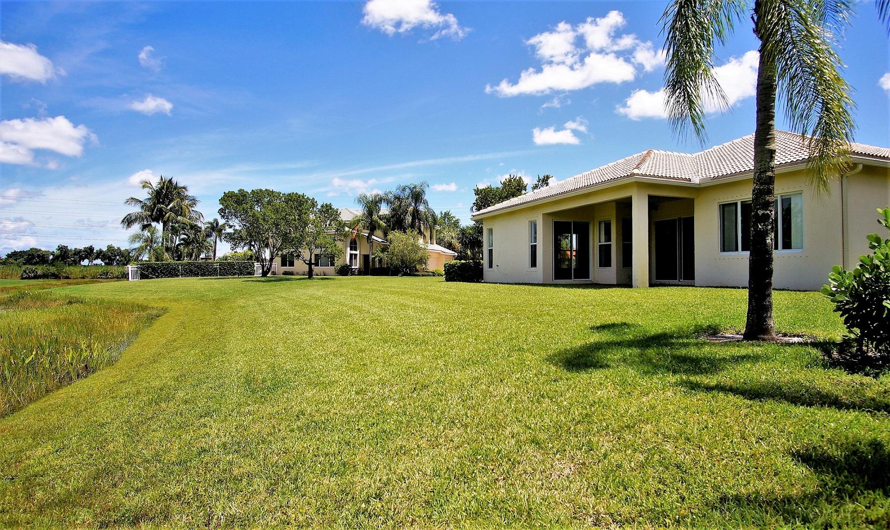 4688 Manderly Drive Wellington, FL 33449 - Photo 20 of 55 a view of a house with a yard
