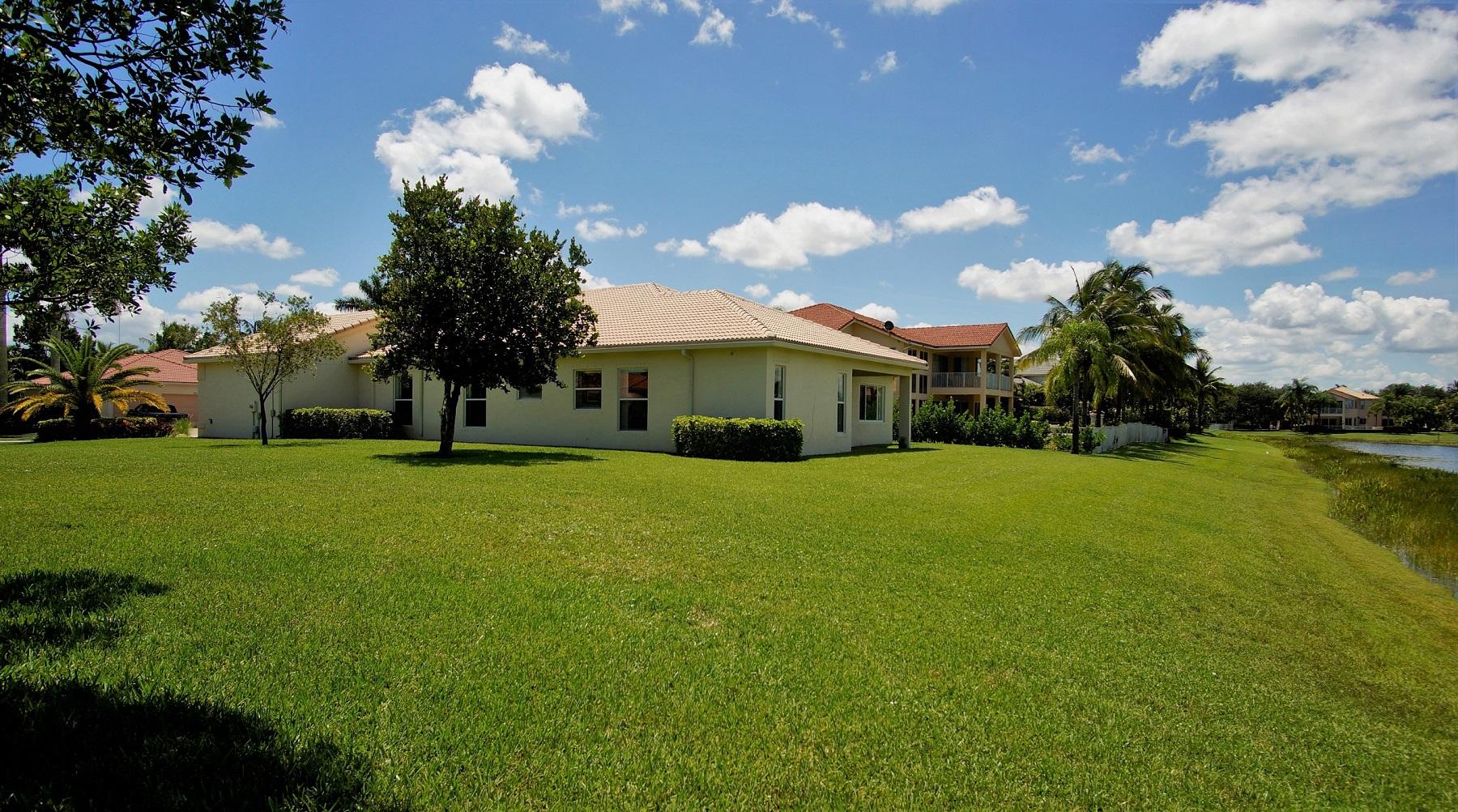 4688 Manderly Drive Wellington, FL 33449 - Photo 21 of 55 a view of yard with swimming pool and green space