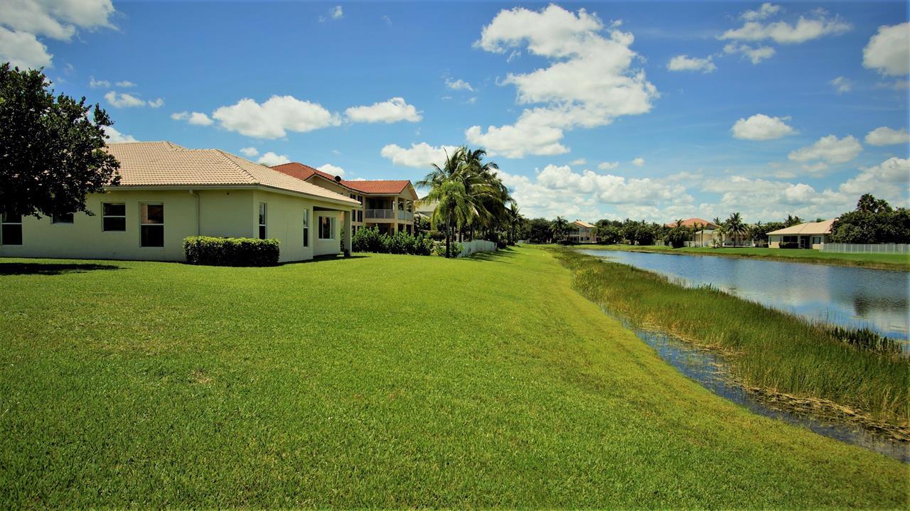 4688 Manderly Drive Wellington, FL 33449 - Photo 4 of 55 a view of a house with a yard and lake view