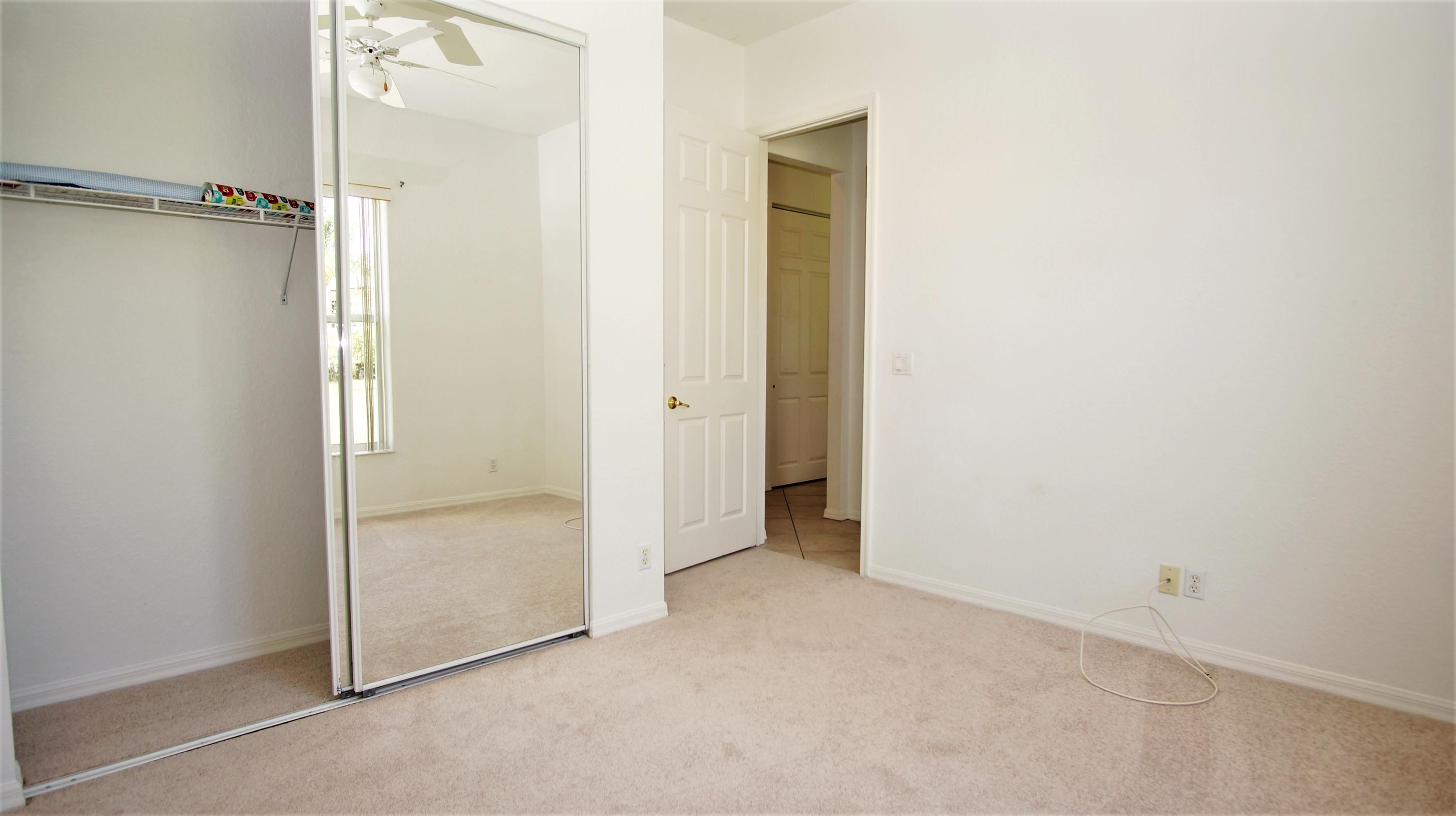 4688 Manderly Drive Wellington, FL 33449 - Photo 37 of 55 an empty room with sliding door