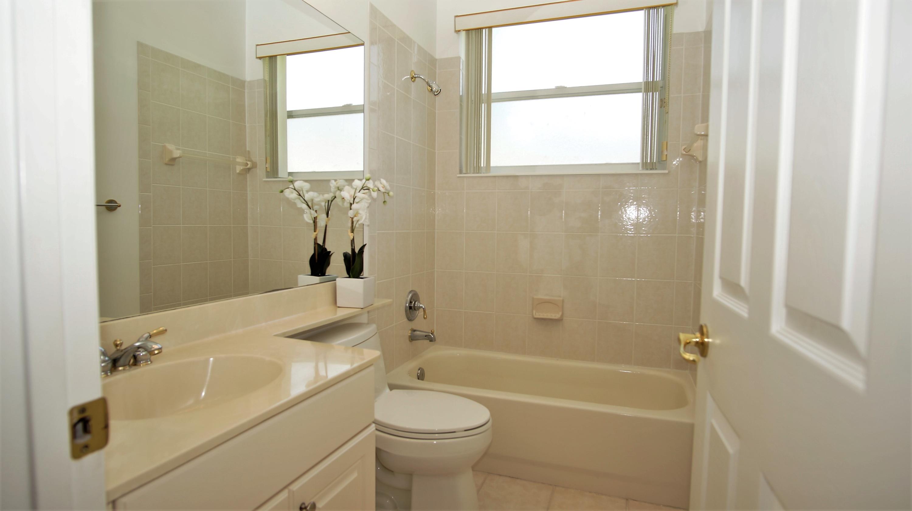 4688 Manderly Drive Wellington, FL 33449 - Photo 38 of 55 a bathroom with a sink a toilet and shower