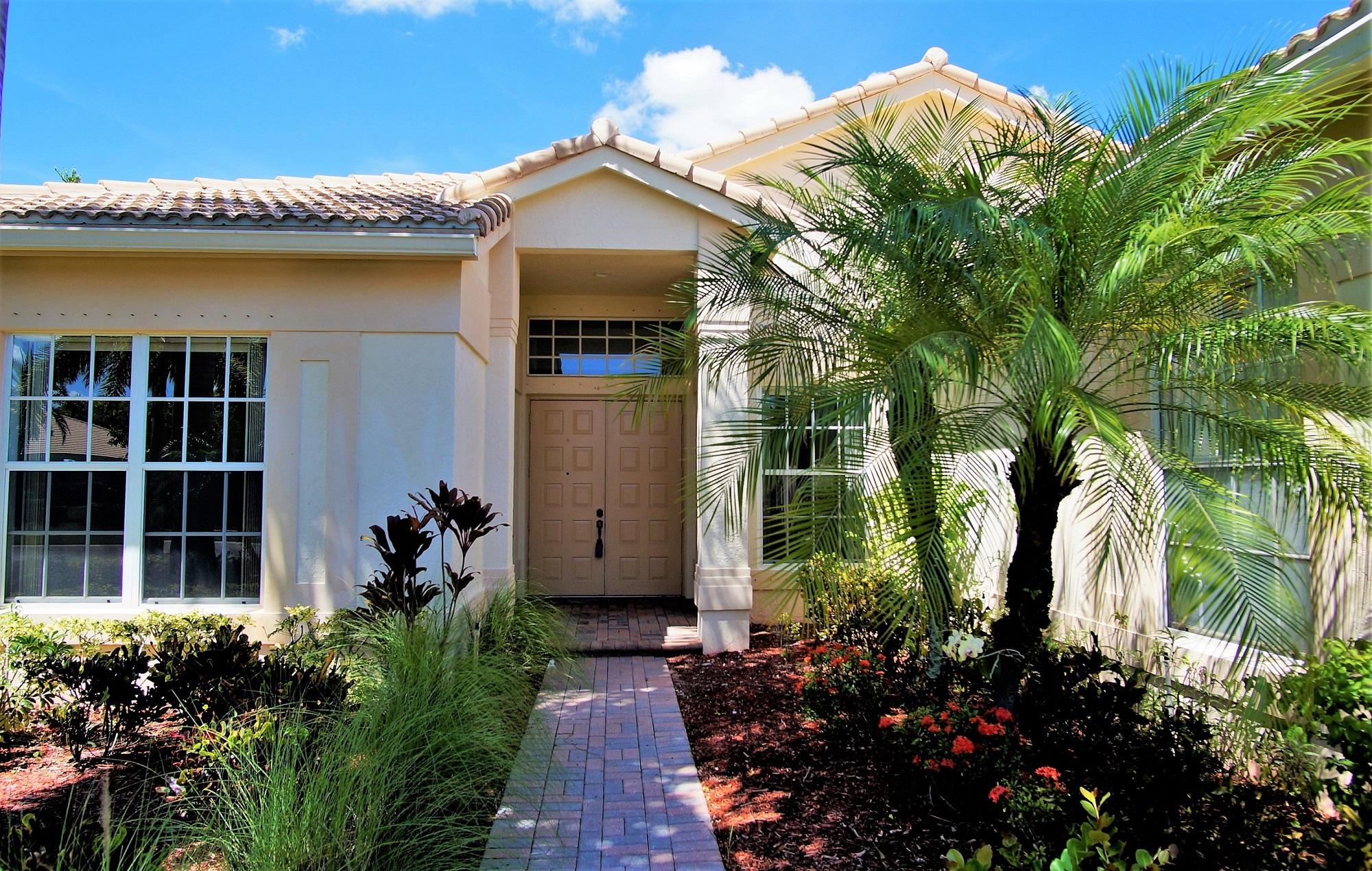 4688 Manderly Drive Wellington, FL 33449 - Photo 5 of 55 a front view of a house with a yard