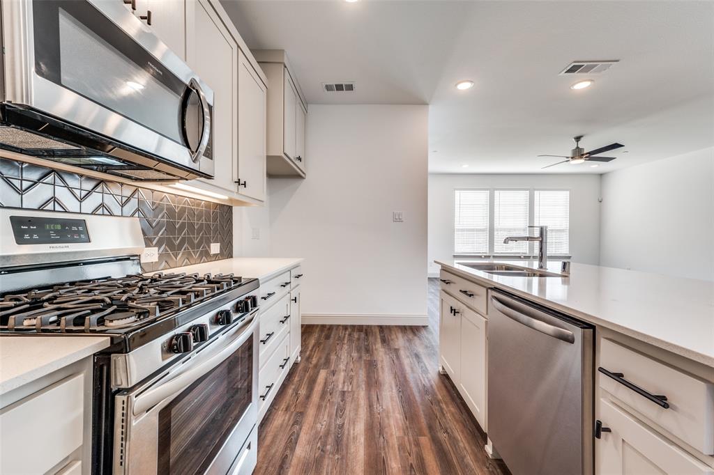 15866 Yellow Elder Road Frisco, TX 75035 - Photo 10 of 25 a kitchen with granite countertop a stove and a sink