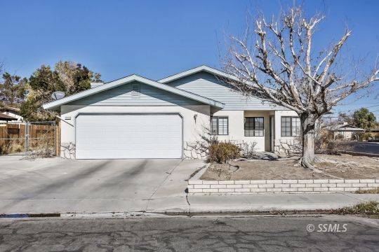 832 Walker Lane Ridgecrest, CA 93555 - Photo 1 of 23 a front view of a house with a yard and garage