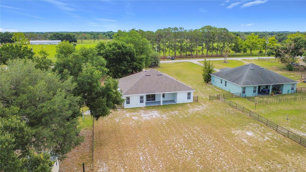 28549 Shirley Shores Road Tavares, FL 32778 - Photo 62 of 65 a view of a house with pool and a yard