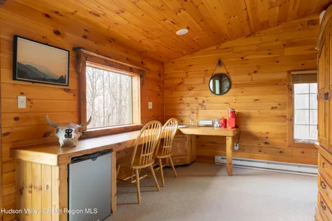 a dining room with furniture and window
