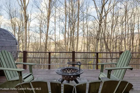 a view of a balcony with a potted plant and wooden floor
