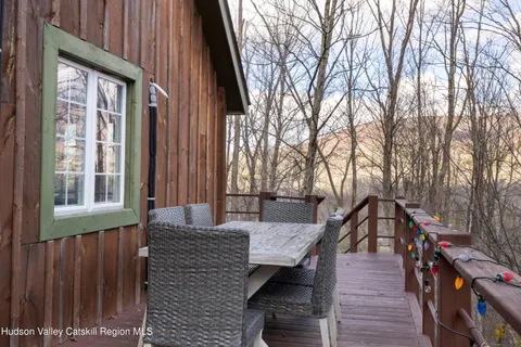 a view of a house with a yard and wooden fence