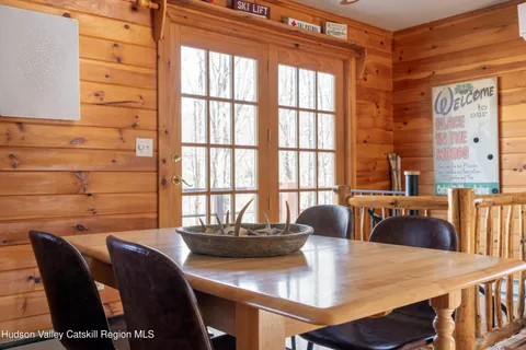 a dining room with furniture and wooden floor