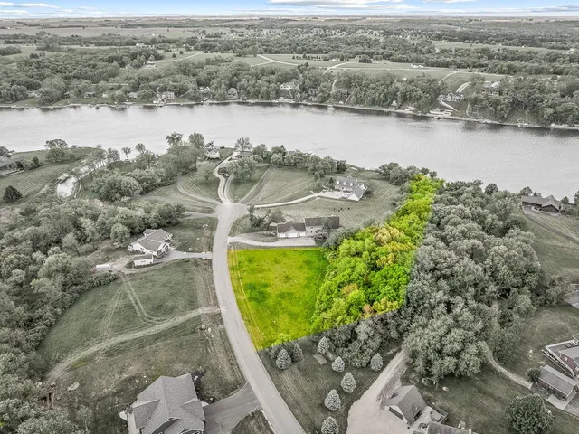 an aerial view of lake residential house and covered with swimming pool
