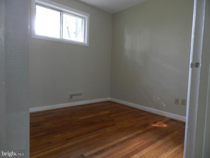 3513 Greenly Street Silver Spring, MD 20906 - Photo 8 of 12 an empty room with wooden floor and windows