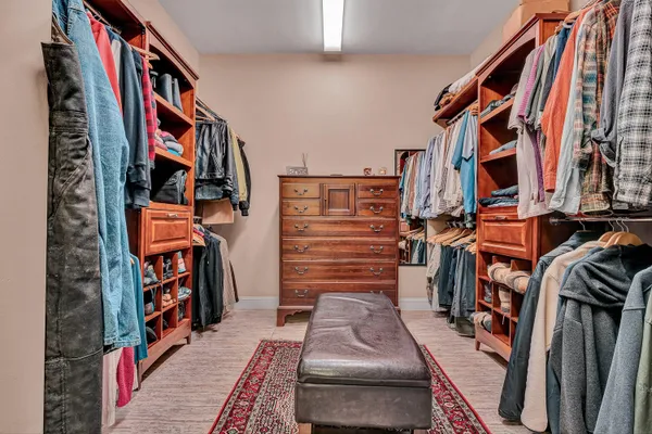a bathroom with a granite countertop toilet sink and mirror