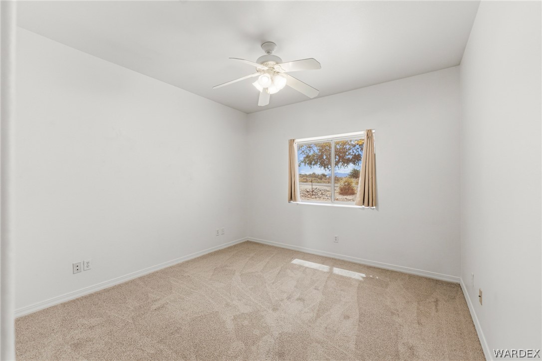 9332 Branded Road Kingman, AZ 86401 - Photo 33 of 44 an empty room with a window and a fan
