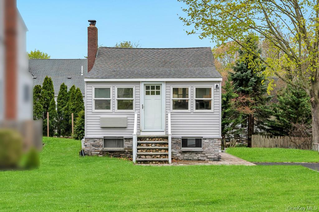 25 Cedar Road Wading River, NY 11792 - Photo 1 of 1 Cottage with stone foundation and gray siding, virtually stage grass