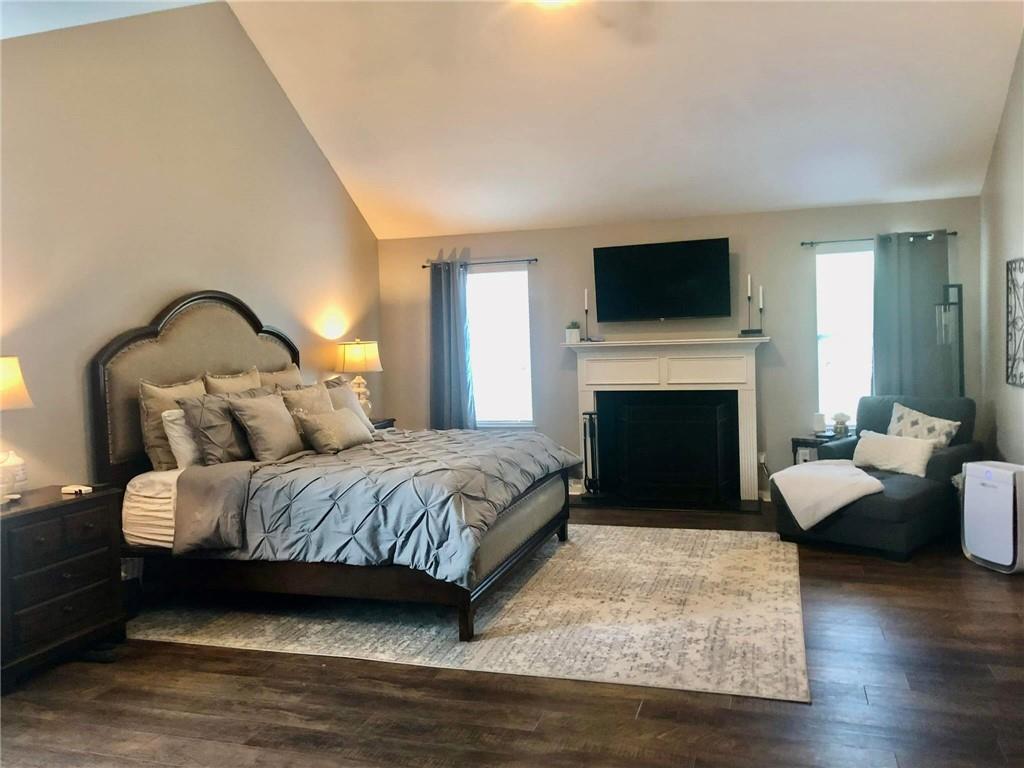 417 Farmwood Way Canton, GA 30115 - Photo 19 of 20 a spacious bedroom with a bed and a flat screen tv