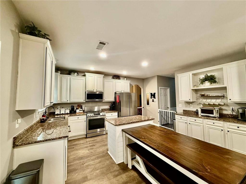417 Farmwood Way Canton, GA 30115 - Photo 6 of 20 a large kitchen with a large counter top space appliances and cabinets