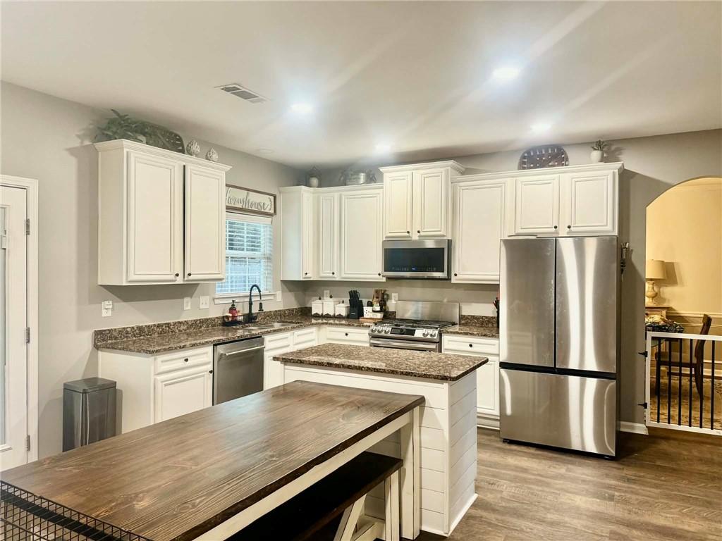 417 Farmwood Way Canton, GA 30115 - Photo 7 of 20 a kitchen with a refrigerator a stove top oven a sink and cabinets