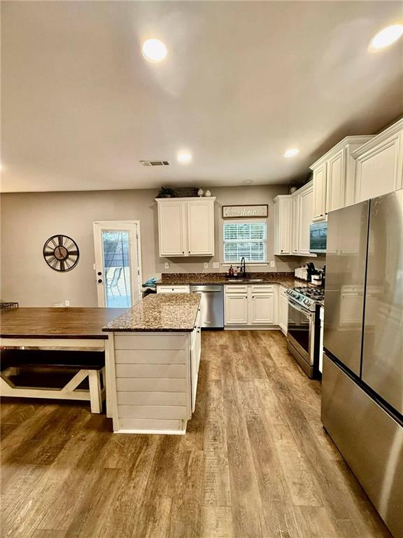 417 Farmwood Way Canton, GA 30115 - Photo 10 of 20 a large kitchen with cabinets and stainless steel appliances