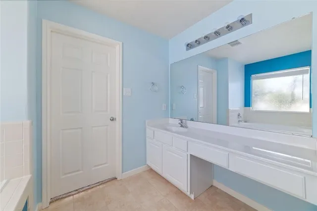 a bathroom with a double vanity sink and mirror