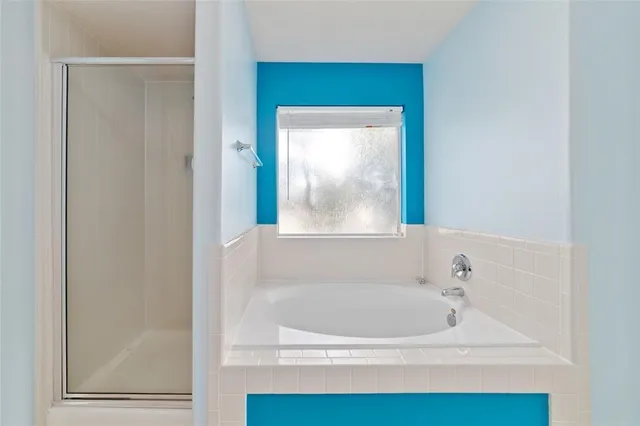 a white bath tub sitting next to a window