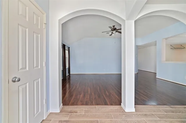 a view of a hallway view with wooden floor and staircase