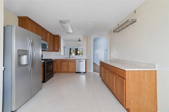 a kitchen with stainless steel appliances a refrigerator and a sink