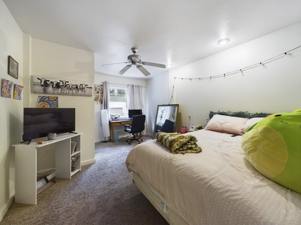 915 Keith Lane, Unit 103 Austin, TX 78705 - Photo 13 of 17 a bedroom with a bed and a flat screen tv