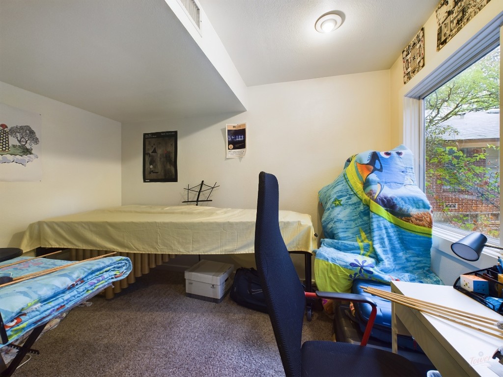 915 Keith Lane, Unit 103 Austin, TX 78705 - Photo 14 of 17 a bedroom with furniture and a window