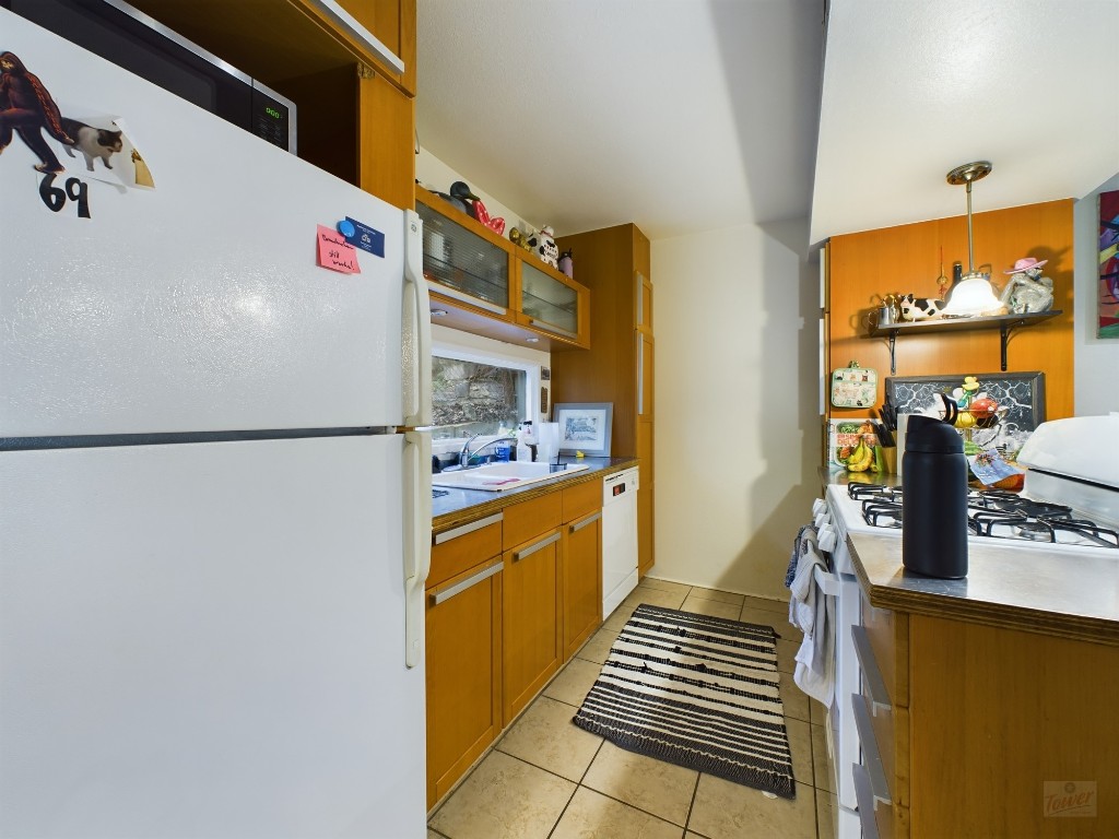 915 Keith Lane, Unit 103 Austin, TX 78705 - Photo 5 of 17 a kitchen with stainless steel appliances a sink and a refrigerator
