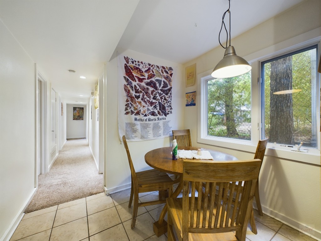 915 Keith Lane, Unit 103 Austin, TX 78705 - Photo 6 of 17 a dining room with furniture a chandelier and wooden floor