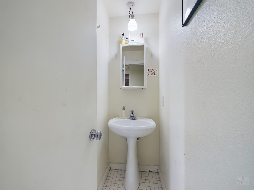915 Keith Lane, Unit 103 Austin, TX 78705 - Photo 8 of 17 a bathroom with a sink and a mirror