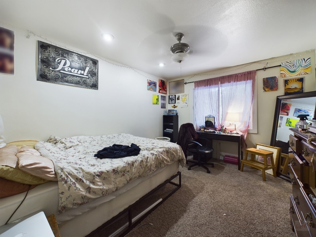 915 Keith Lane, Unit 103 Austin, TX 78705 - Photo 9 of 17 a bed room with a bed furniture and a chandelier