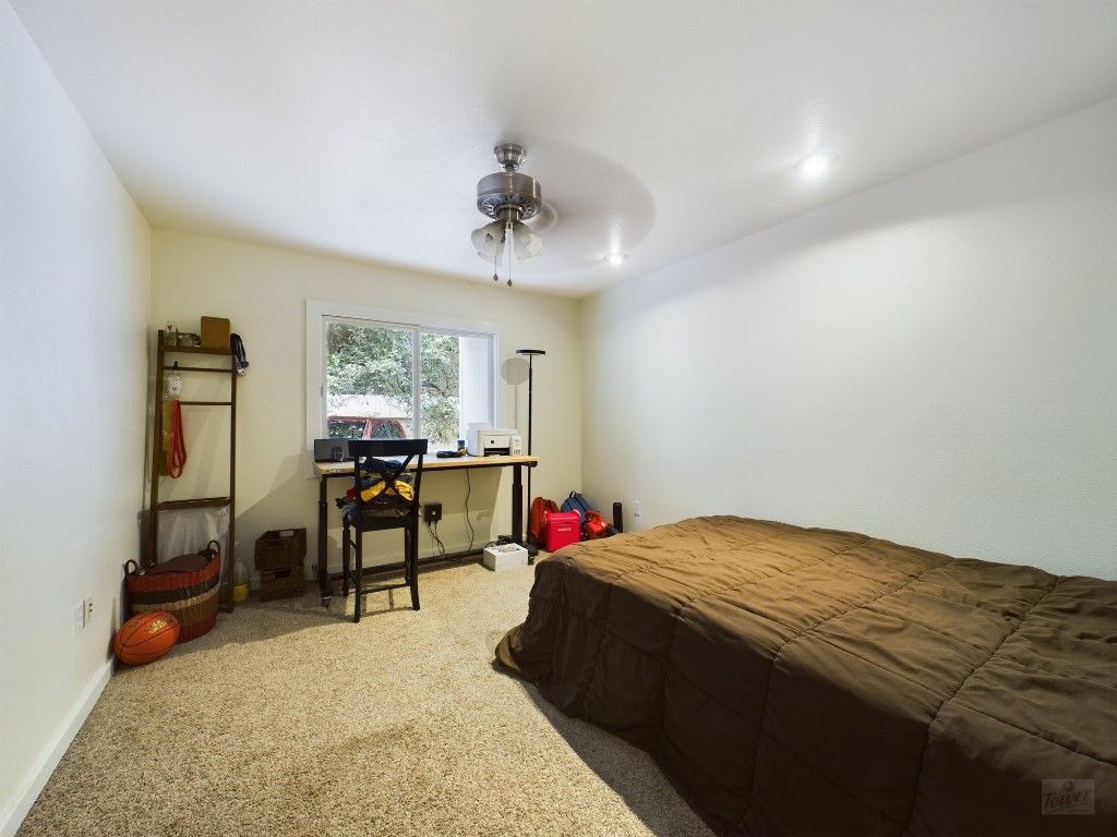915 Keith Lane, Unit 103 Austin, TX 78705 - Photo 10 of 17 a bedroom with a bed a desk and chair