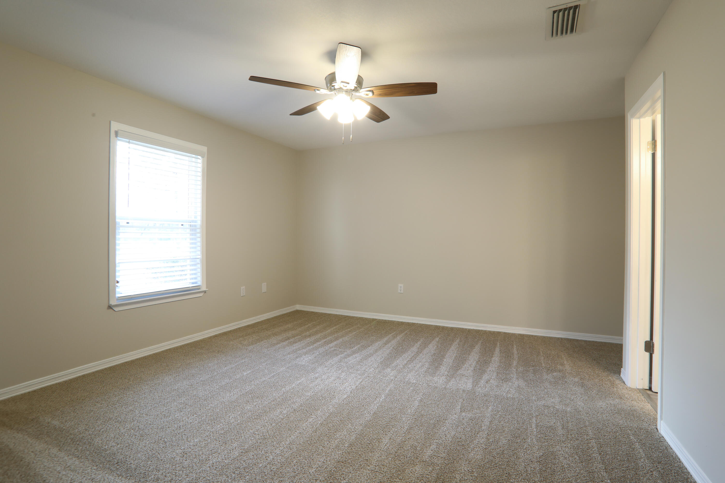 5842 Old Bethel Road Crestview, FL 32536 - Photo 15 of 18 wooden floor in an empty room with a window