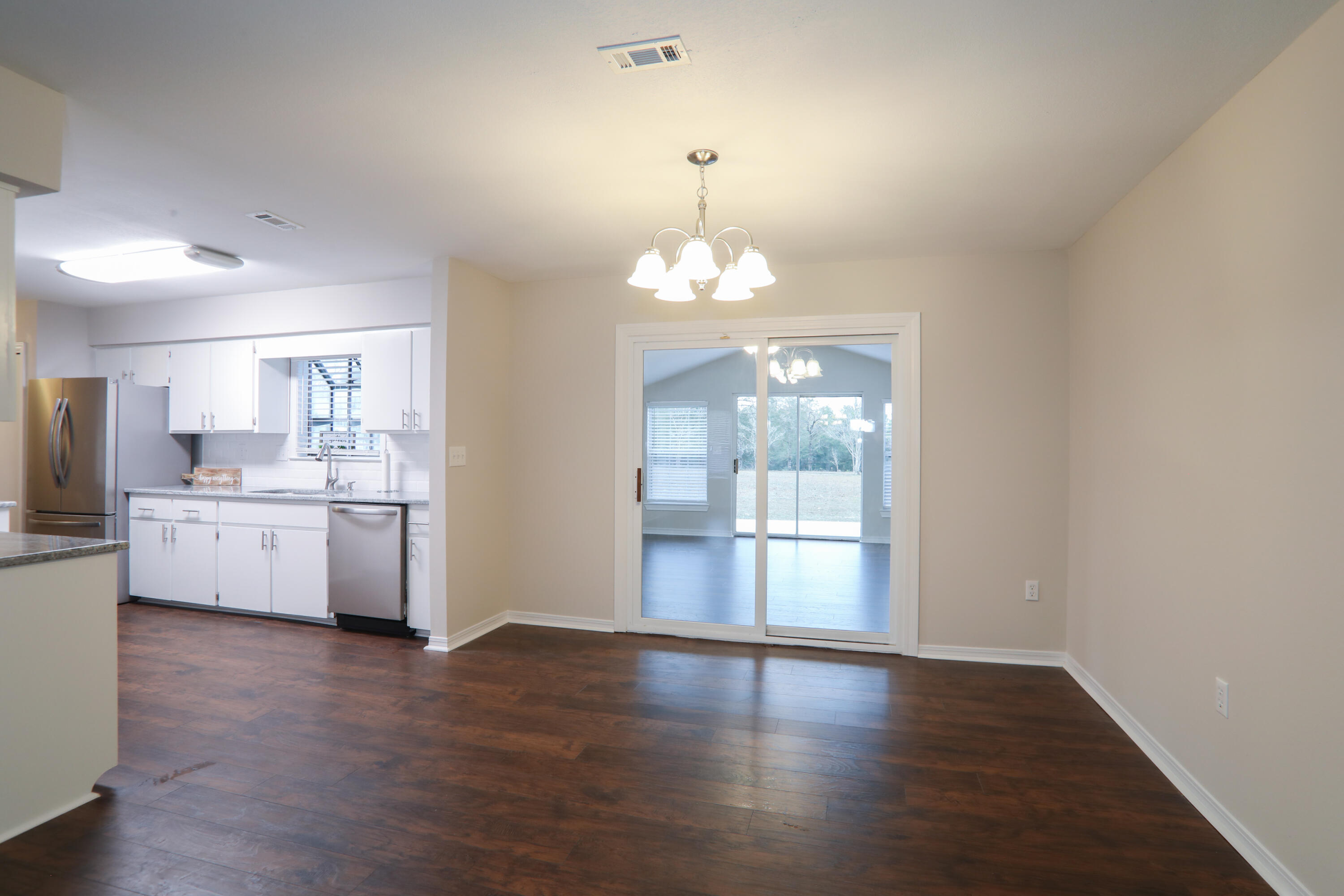 5842 Old Bethel Road Crestview, FL 32536 - Photo 4 of 18 a view of a kitchen with wooden floor and a kitchen