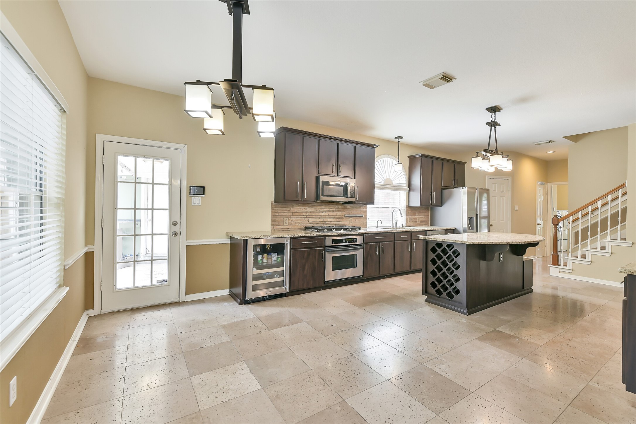 5803 Song Ridge Court Houston, TX 77041 - Photo 13 of 45 a large kitchen with a lot of counter space and a chandelier