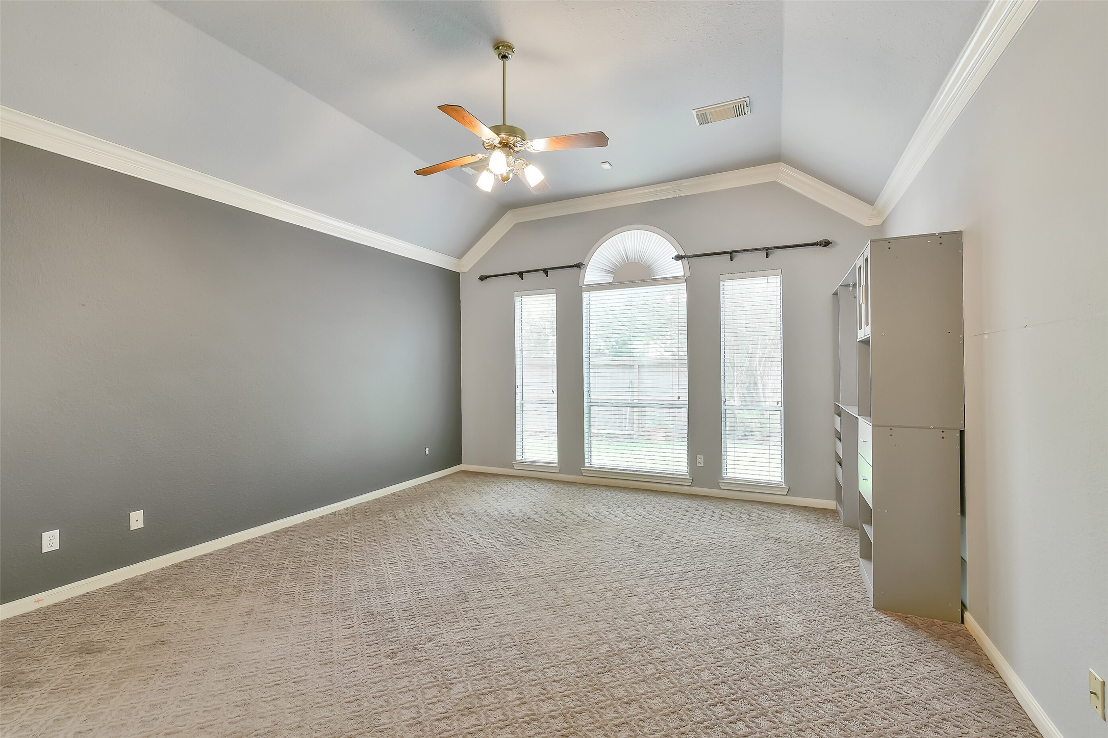 5803 Song Ridge Court Houston, TX 77041 - Photo 18 of 45 an empty room with chandelier fan and windows