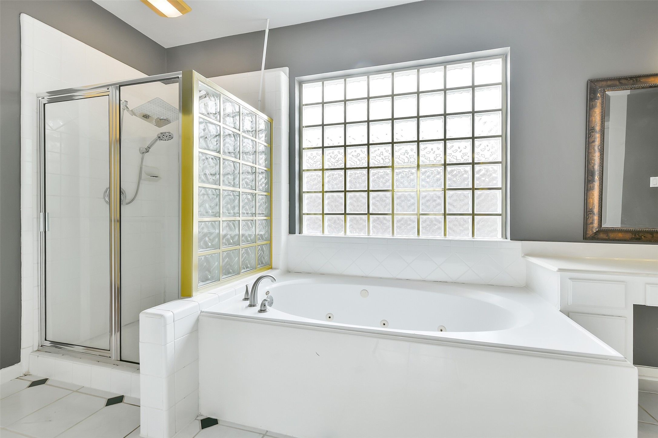 5803 Song Ridge Court Houston, TX 77041 - Photo 23 of 45 a bathroom with a bathtub and a shower