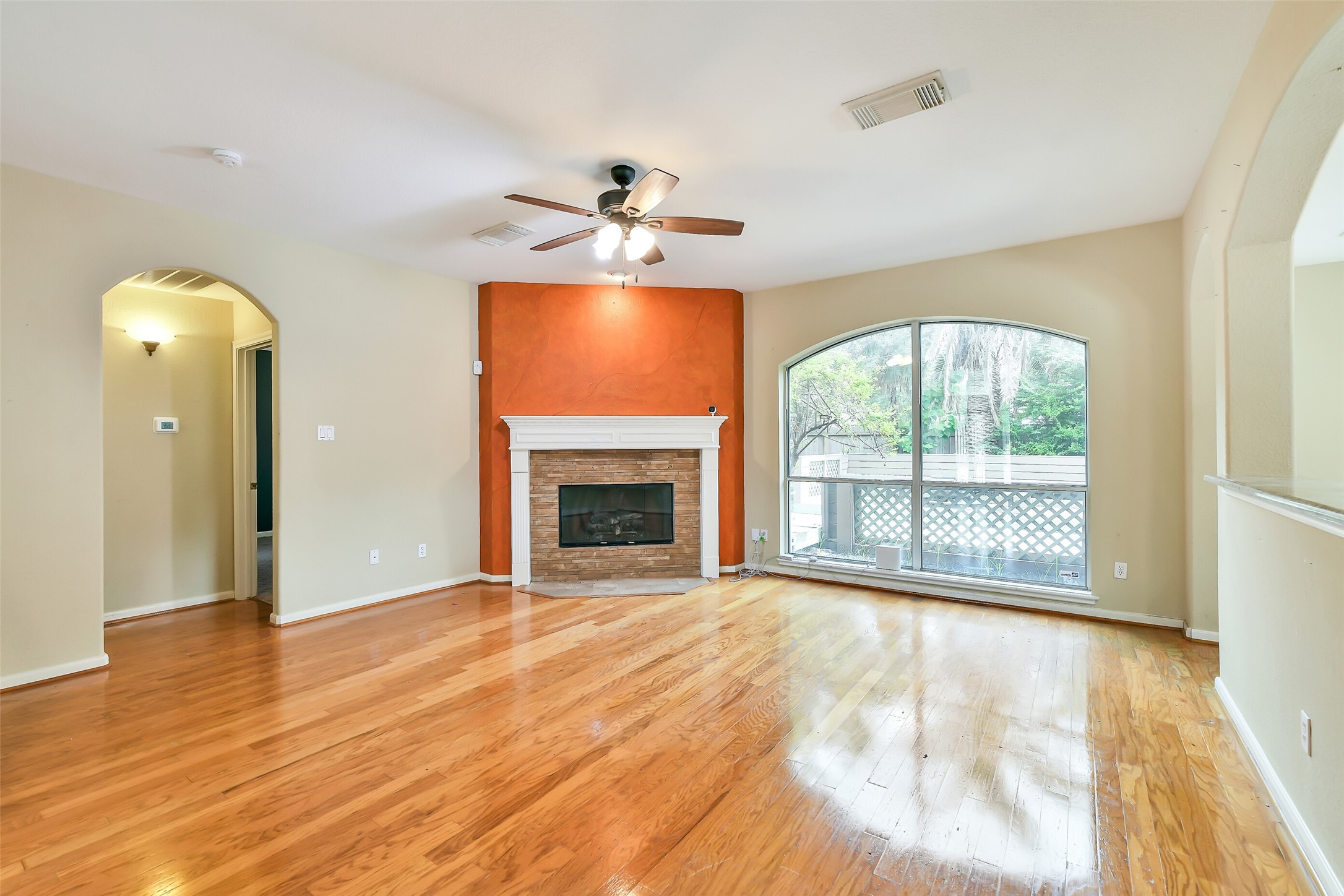 5803 Song Ridge Court Houston, TX 77041 - Photo 4 of 45 a view of an empty room with a window and wooden floor