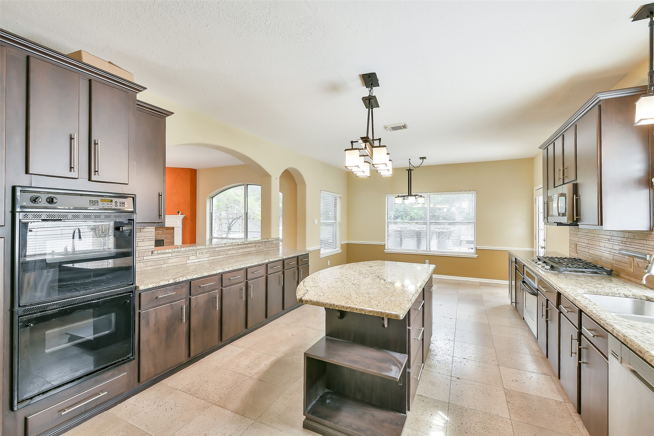 5803 Song Ridge Court Houston, TX 77041 - Photo 9 of 45 a large kitchen with stainless steel appliances granite countertop a stove oven and a sink with cabinets