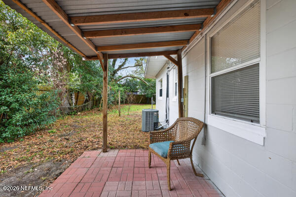 7143 King Arthur Road North Jacksonville, FL 32211 - Photo 15 of 18 a balcony with furniture and wooden floor