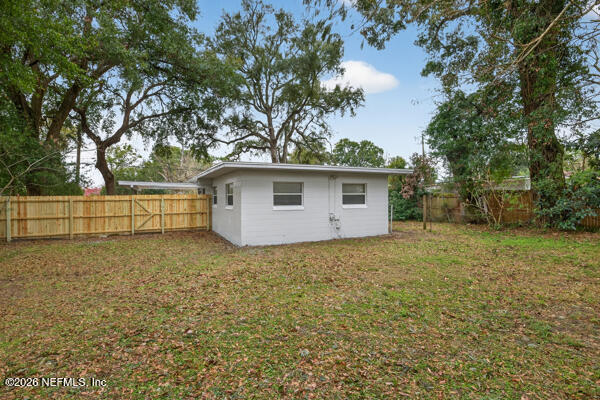 7143 King Arthur Road North Jacksonville, FL 32211 - Photo 17 of 18 a backyard of a house with lots of green space