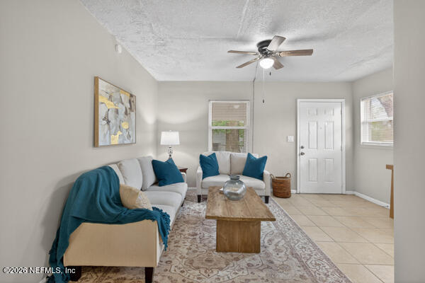 7143 King Arthur Road North Jacksonville, FL 32211 - Photo 7 of 18 a living room with furniture and a ceiling fan