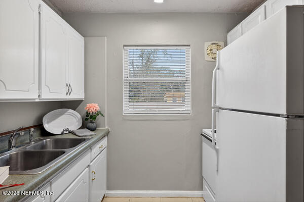 7143 King Arthur Road North Jacksonville, FL 32211 - Photo 8 of 18 a kitchen with a refrigerator and a sink