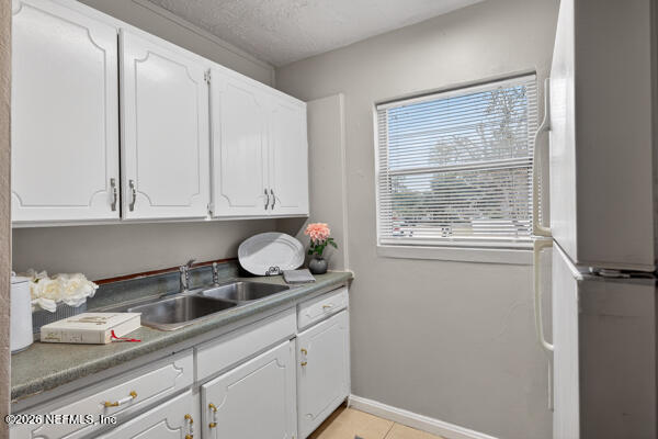 7143 King Arthur Road North Jacksonville, FL 32211 - Photo 9 of 18 a kitchen with granite countertop white cabinets and white appliances