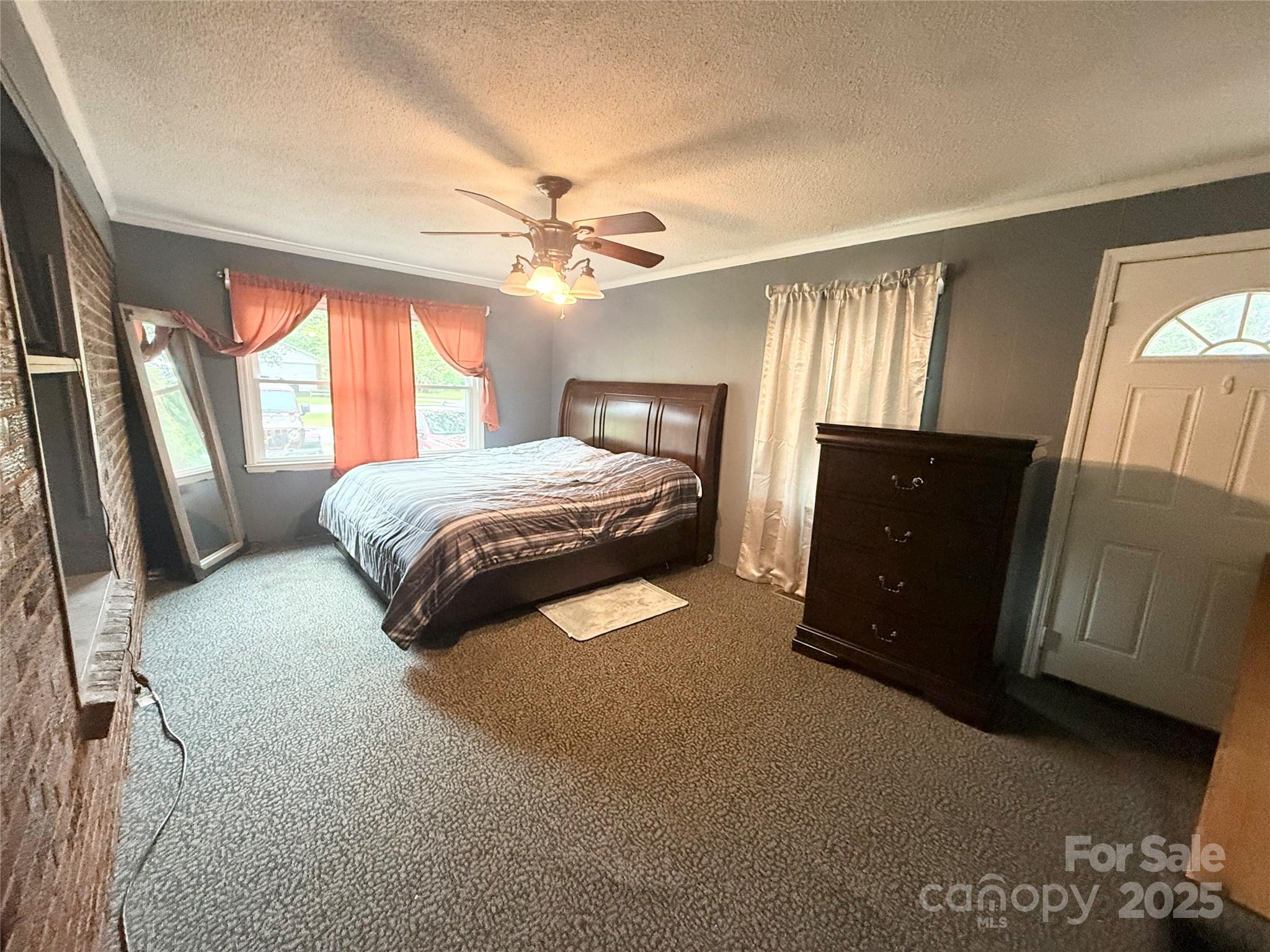 101 Windsor Drive Cheraw, SC 29520 - Photo 11 of 17 a spacious bedroom with a bed and a chandelier