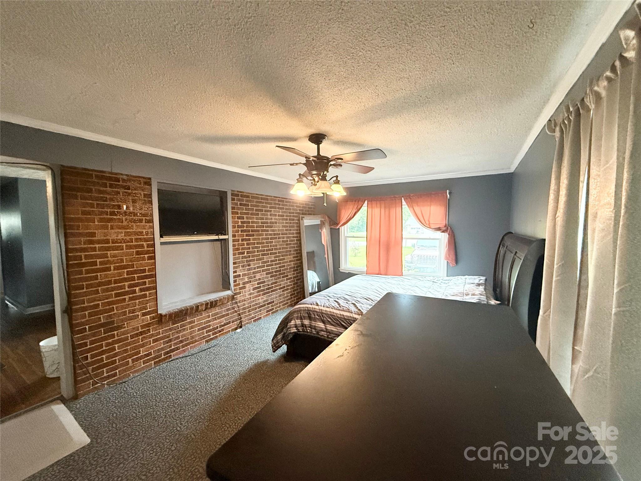 101 Windsor Drive Cheraw, SC 29520 - Photo 12 of 17 a bedroom with a bed and a flat screen tv