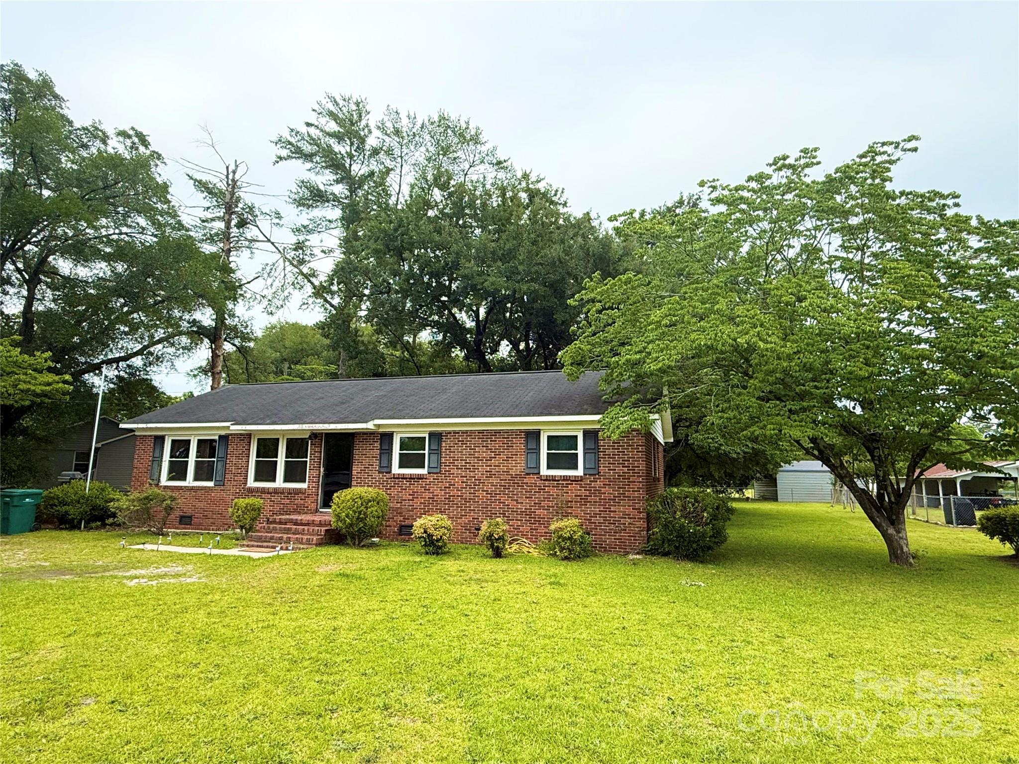101 Windsor Drive Cheraw, SC 29520 - Photo 2 of 17 a front view of house with yard and green space