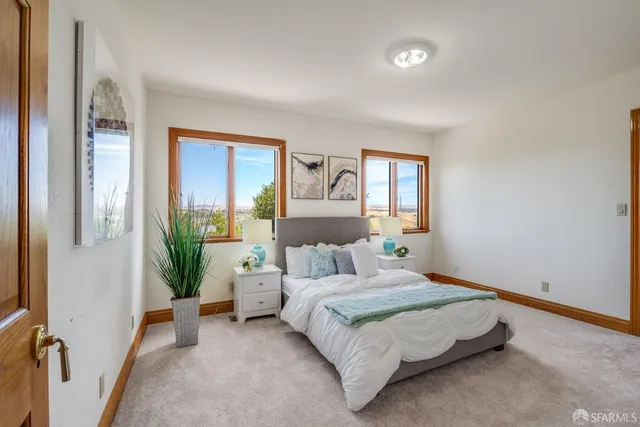 a bedroom with a balcony a bed and a couch