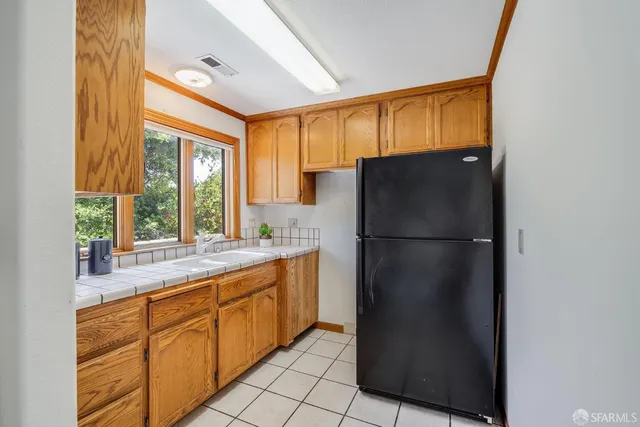a kitchen with a refrigerator and a sink